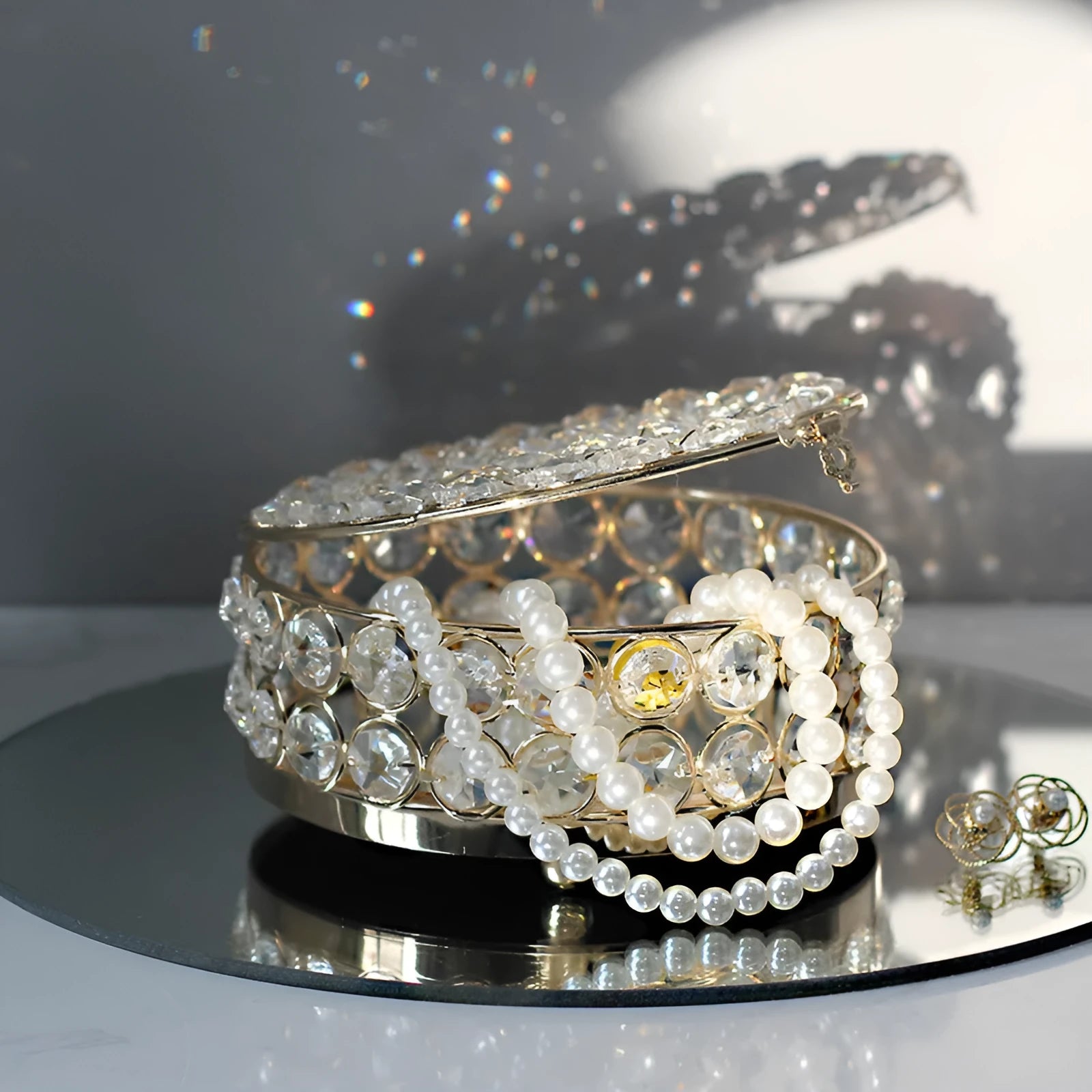French gold metal jewellery box with a transparent crystal glass lid for storing rings and necklaces.