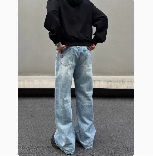 Men's blue straight leg jeans with whisker wash detailing and visible stitching on medium-high waist