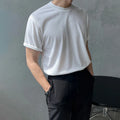 A man's slim-fit cotton T-shirt in solid white, showing the regular half-length sleeves and round neck.