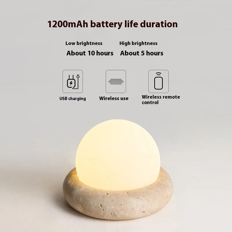 Cream colour bedside night lamp with remote control on wooden bedside table