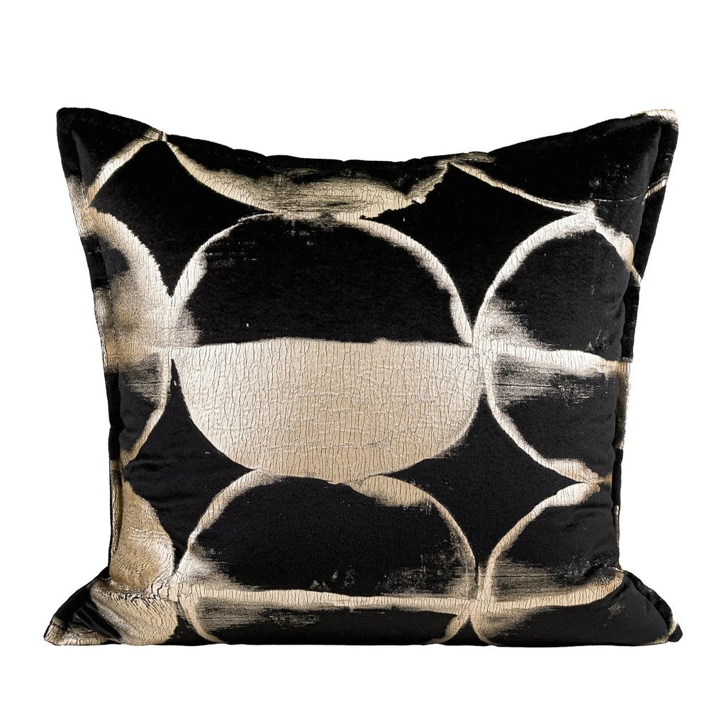 Black and gold abstract pattern flannel decorative cushion on a grey sofa.