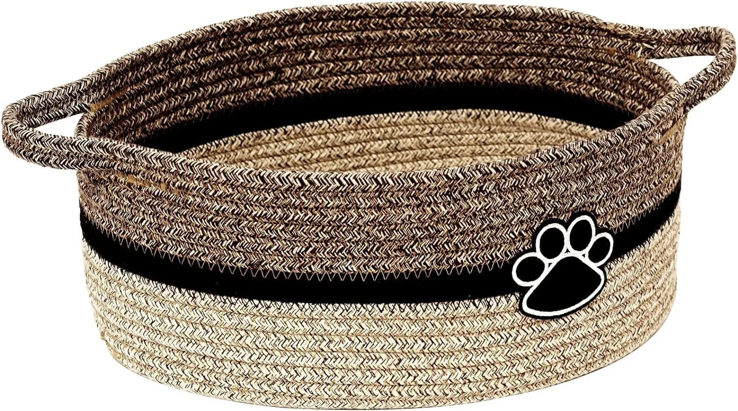 Light beige handmade woven cotton rope storage basket with a handle on a wooden surface.