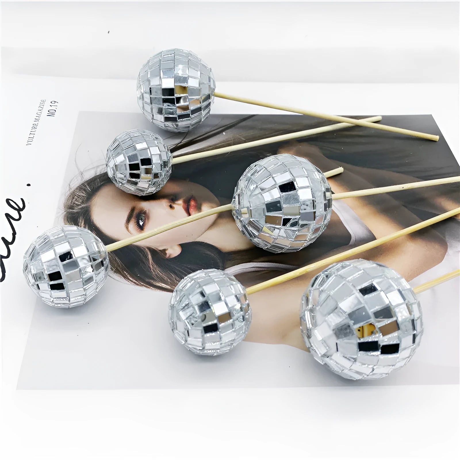 Glass disco ball cake decoration on a wooden stick, shown in different sizes for birthday cakes.