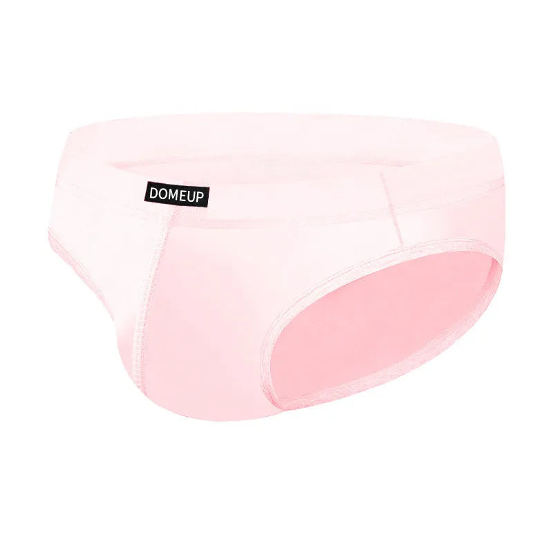 Men's solid colour seamless low-waist briefs in white, black, and pink laid flat.