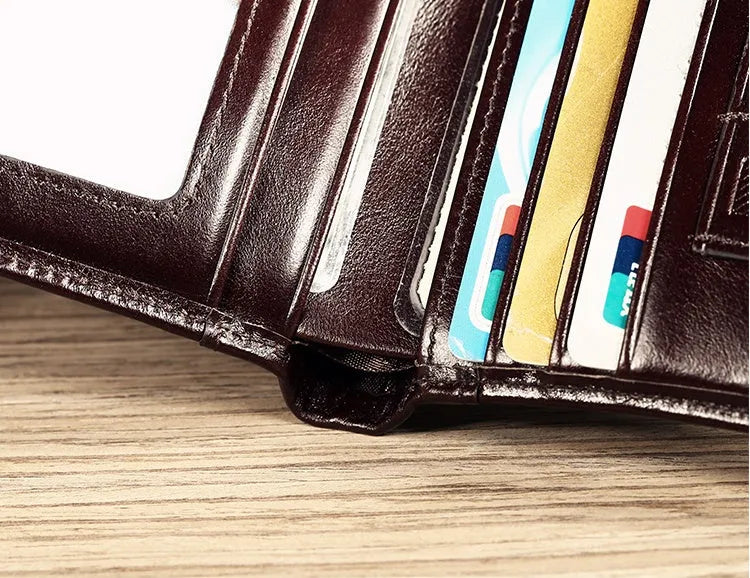 Men's black leather wallet open to show internal compartments: photo slot, card slots, banknote folder, and change pocket.