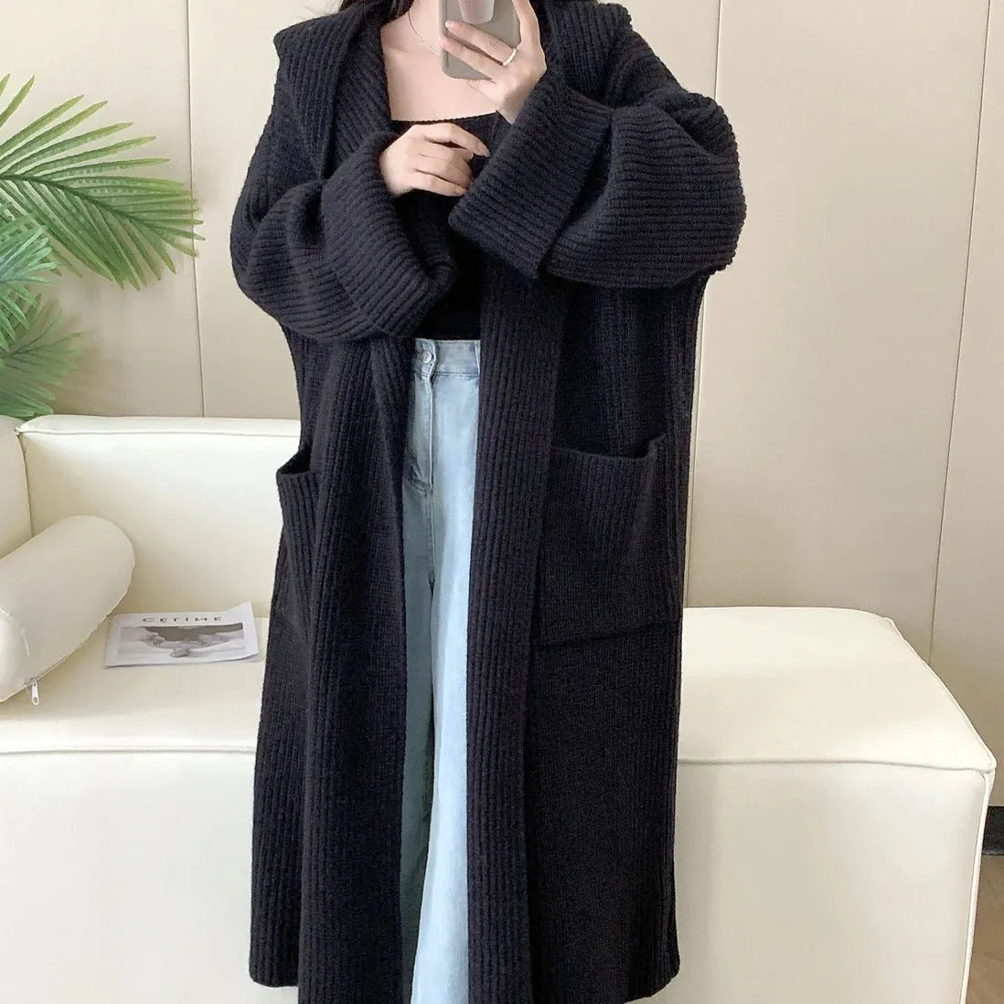 Loose hooded acrylic cardigan coat for women in beige, showing long length and raglan sleeves.