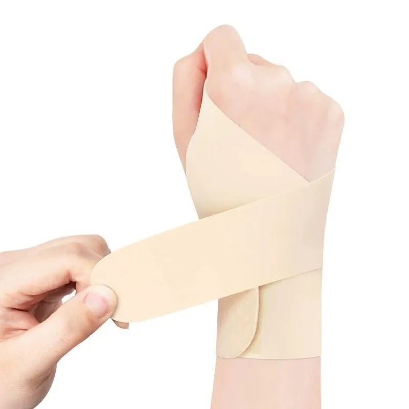 Adjustable black athletic wristguard shown fastened on a wrist.