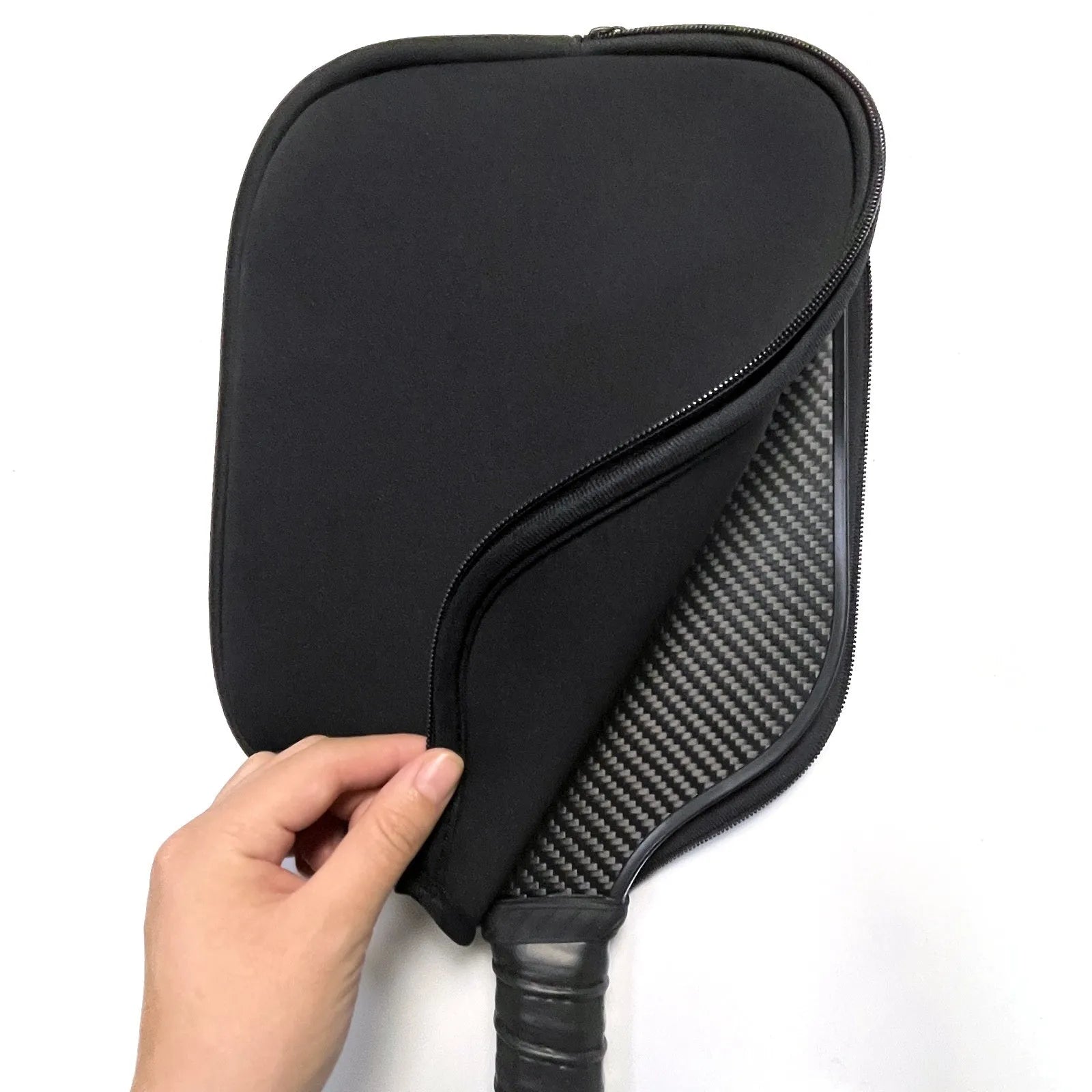 Black neoprene protective sleeve for table tennis racket on a table tennis table