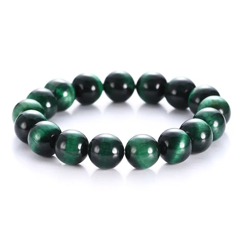 Polished green tiger eye stone bracelet with geometric beads in various sizes on wrist