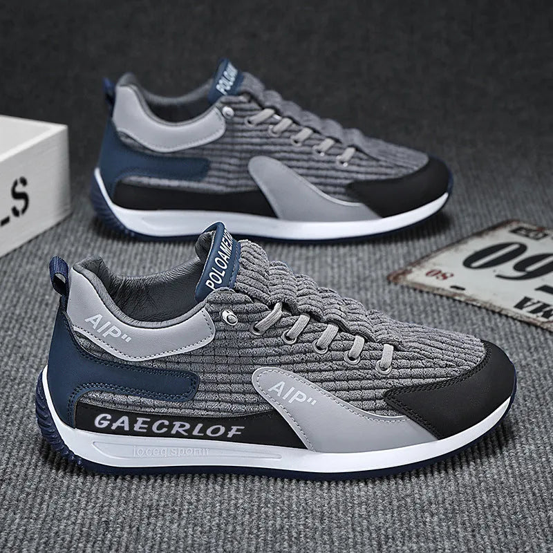 Men's grey and green mesh running shoes with round toe and lace-up design shown from side view