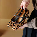 Women's black square toe stiletto heels with horse hair upper and ankle strap buckle.