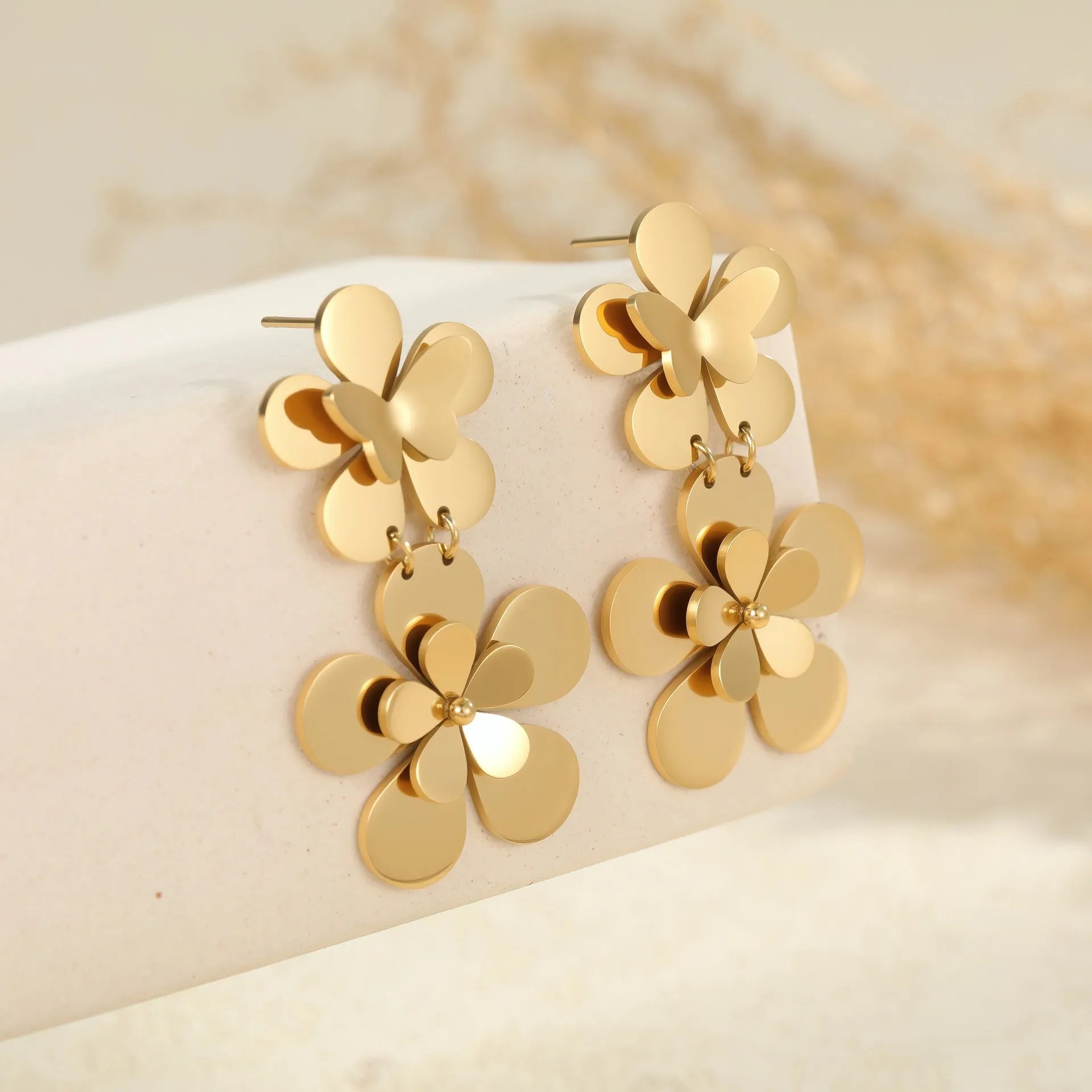 Gold electroplated stainless steel flower butterfly earrings for women with geometric zodiac design