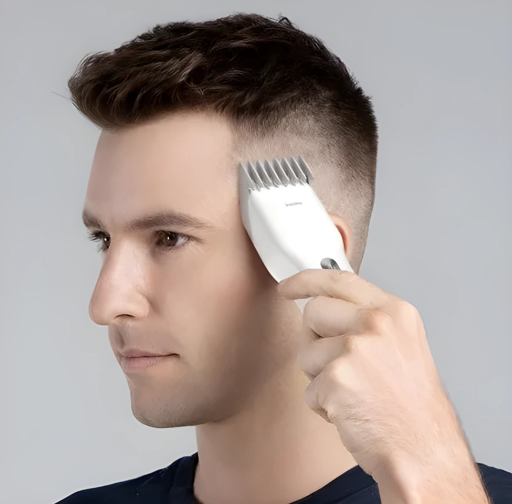 Black cordless hair clipper with ceramic blades and adjustable length comb
