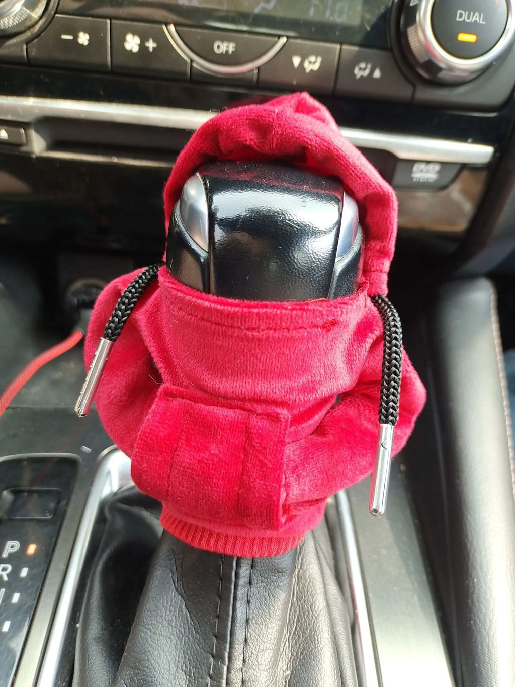 Pure cotton car gear lever sweater decoration in multiple colours on a gear stick.