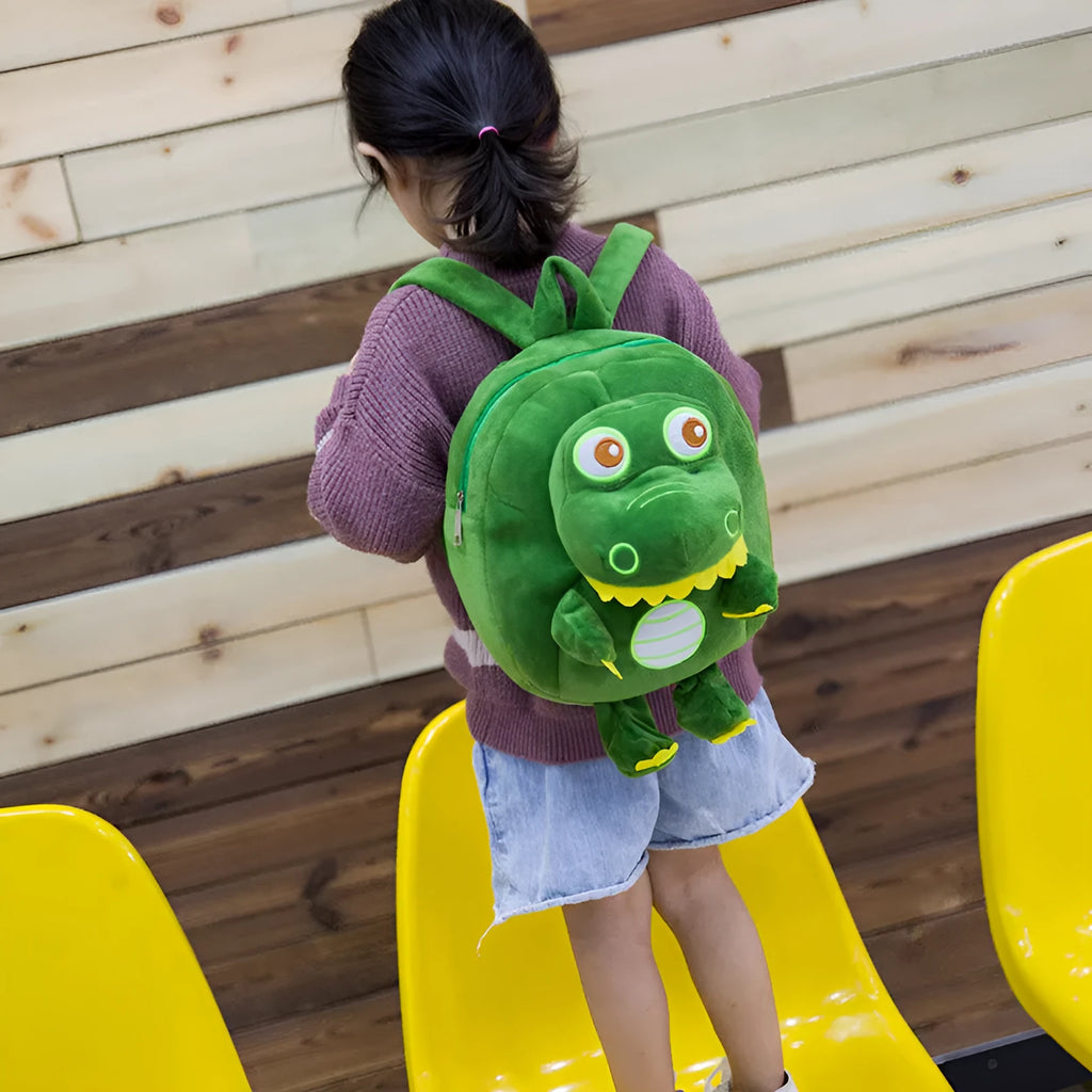 Blue dinosaur plush backpack for children with embroidery, soft handle, and under 20-litre capacity