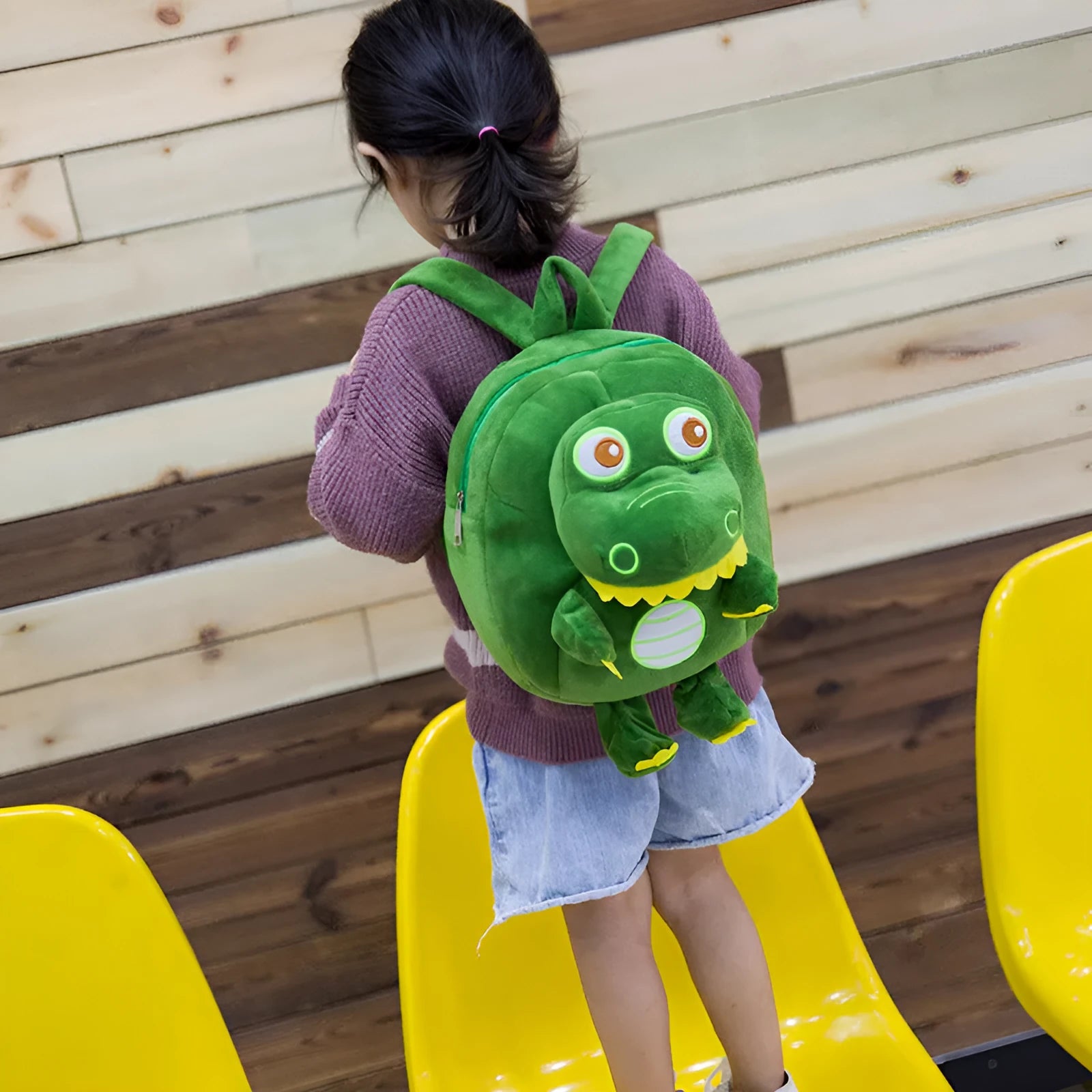 Blue dinosaur plush backpack for children with embroidery, soft handle, and under 20-litre capacity