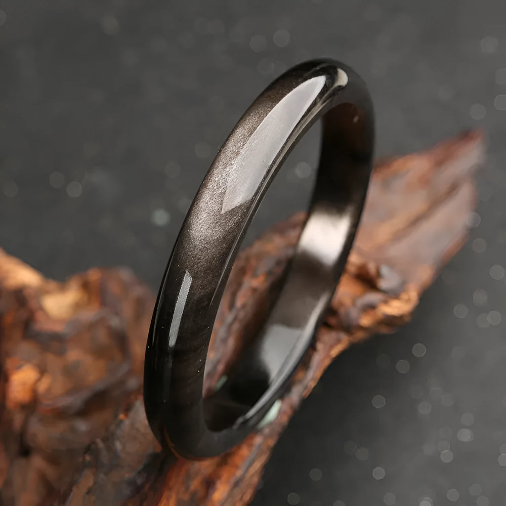 Natural silver stone cat's eye geometric bracelet in crystal and alloy on a wrist.