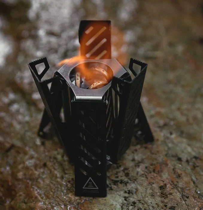 Hexagon foldable alcohol camping stove in black colour showing compact 9.5x8.5x15cm dimensions