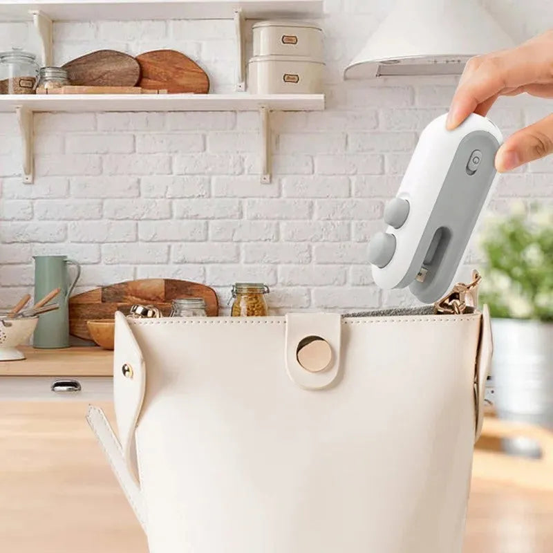 Blue handheld USB rechargeable heat sealer with magnetic back and cutter blade