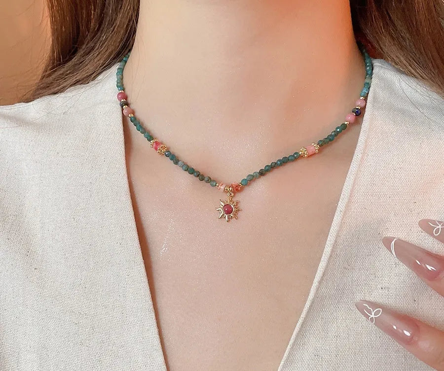 French royal style necklace with sun pendant, freshwater pearls, and adjustable metal chain.
