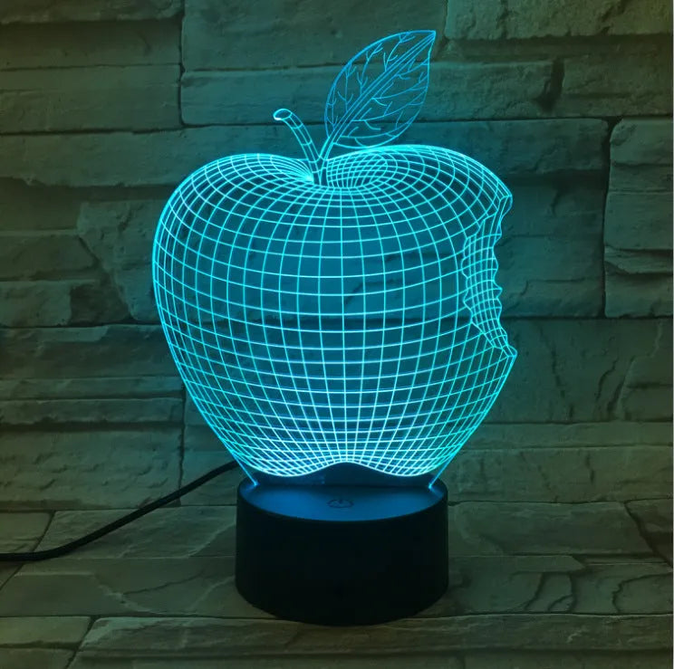 Colourful 3D fruit shaped night light with touch control on a table.