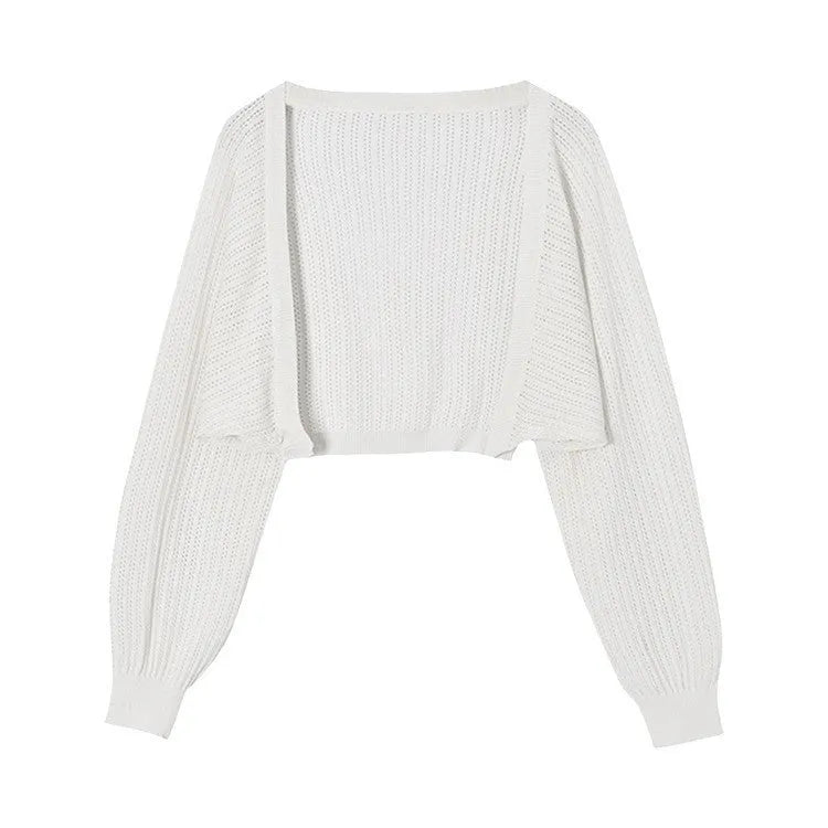 Thin loose linen blouse with hollow out lantern sleeves in apricot colour on a hanger.