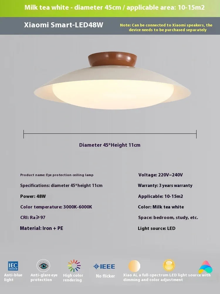 Modern flying saucer shaped ceiling lamp with an iron shade, shown in a cream yellow finish.