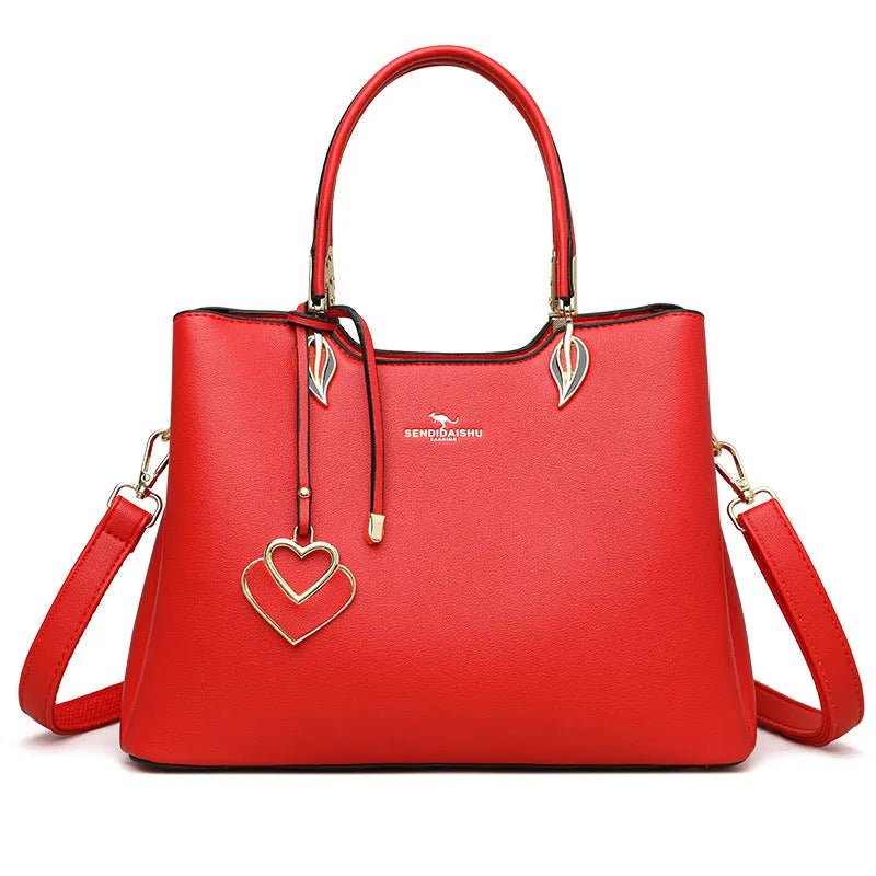 Women's black PU messenger bag with multi-layer design and visible sewing thread detail.