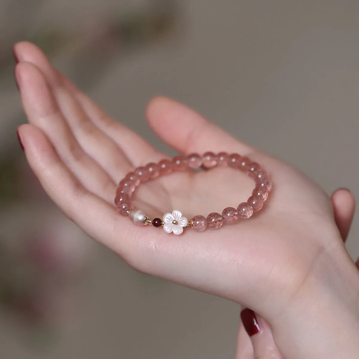 Women's casual crystal bracelet with a strawberry quartz peach blossom flower charm.