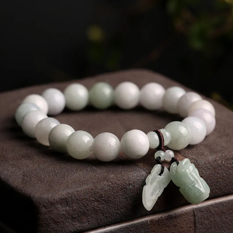 Natural jade geometric bracelet with hanging charm showing Apple design option