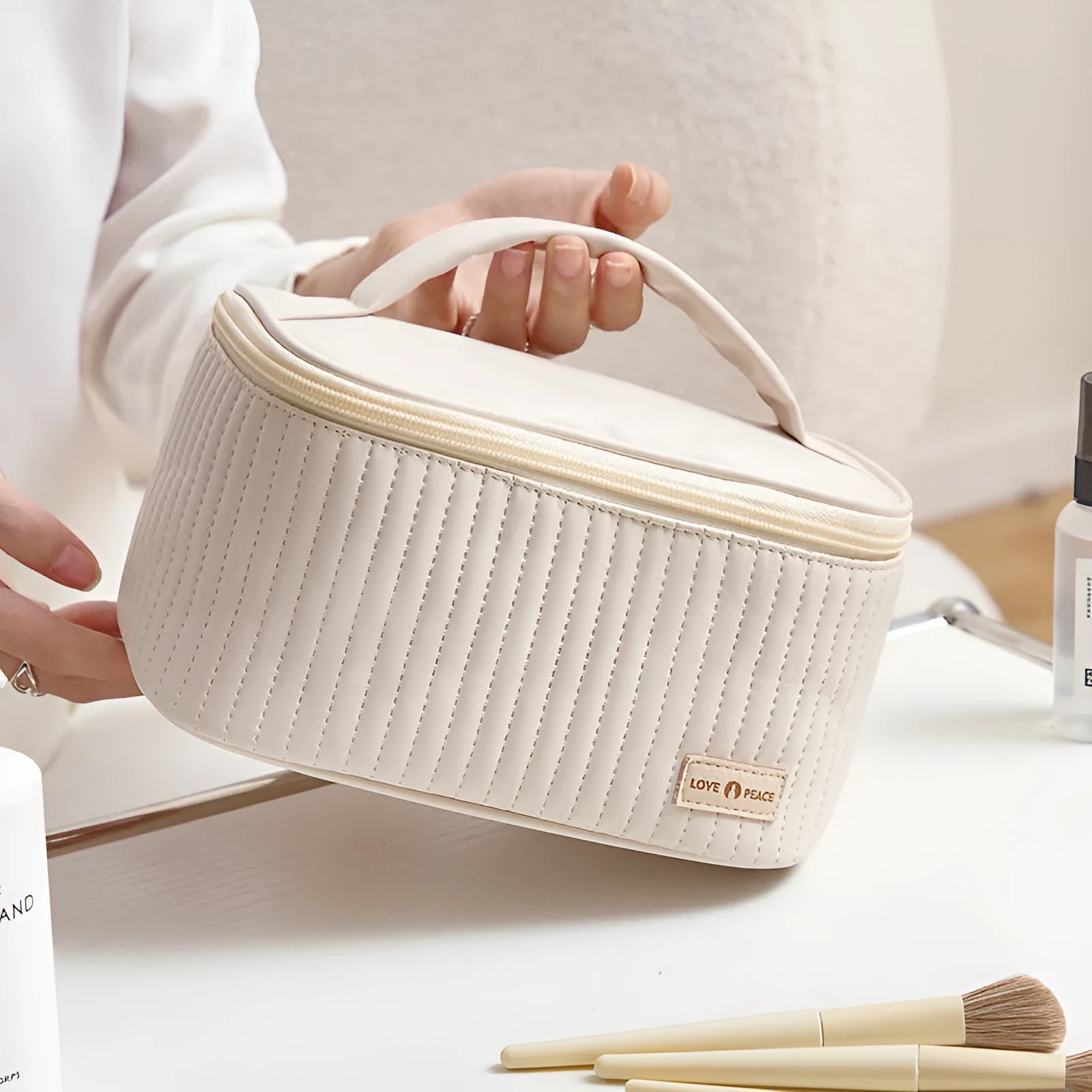 Open-top pink PU leather cake-style makeup bag on a table