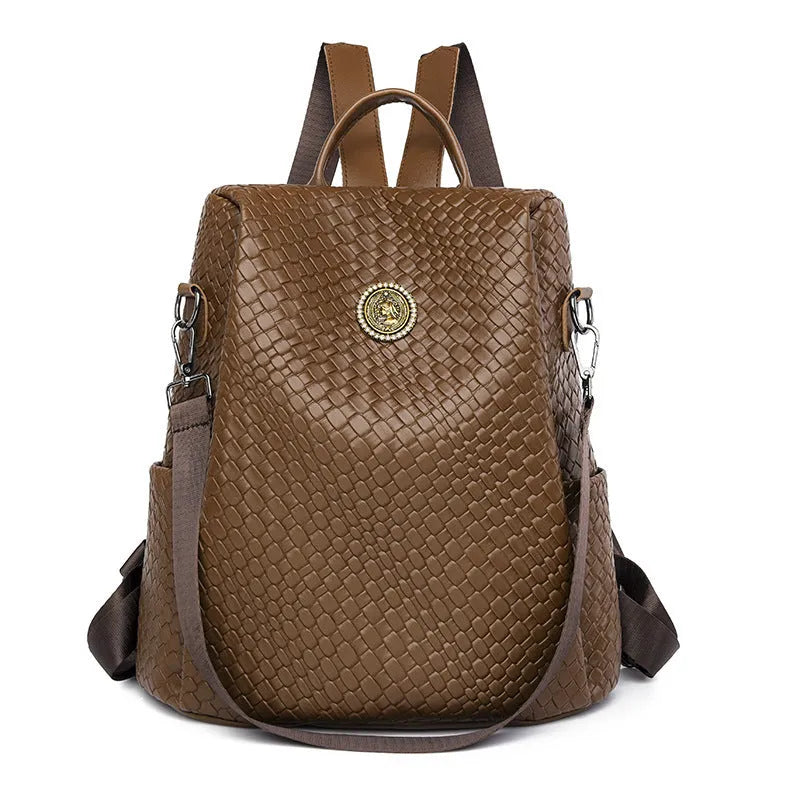 Women's black anti-theft backpack with woven detailing and multiple zipped compartments.