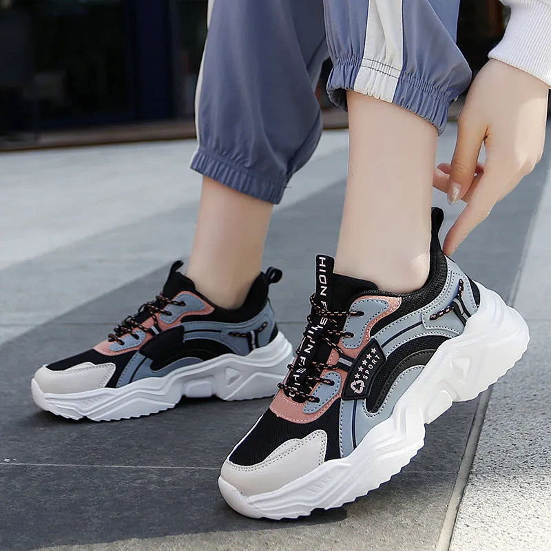 Women's white chunky casual sports shoes with mesh upper and thick mid-heel sole.