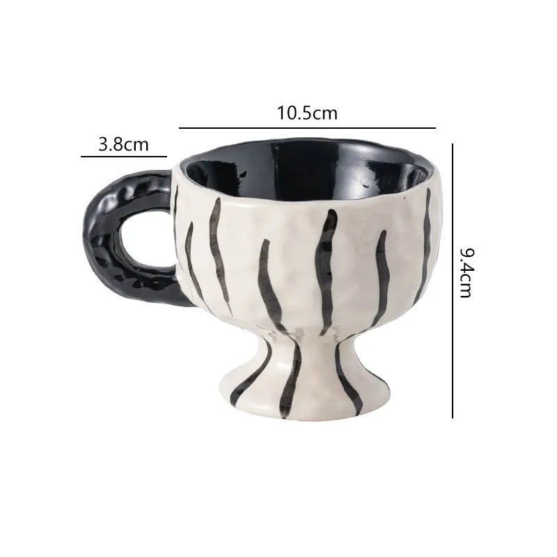 Hand-pinched irregular ceramic mug in a solid colour, showing unique handmade shape.