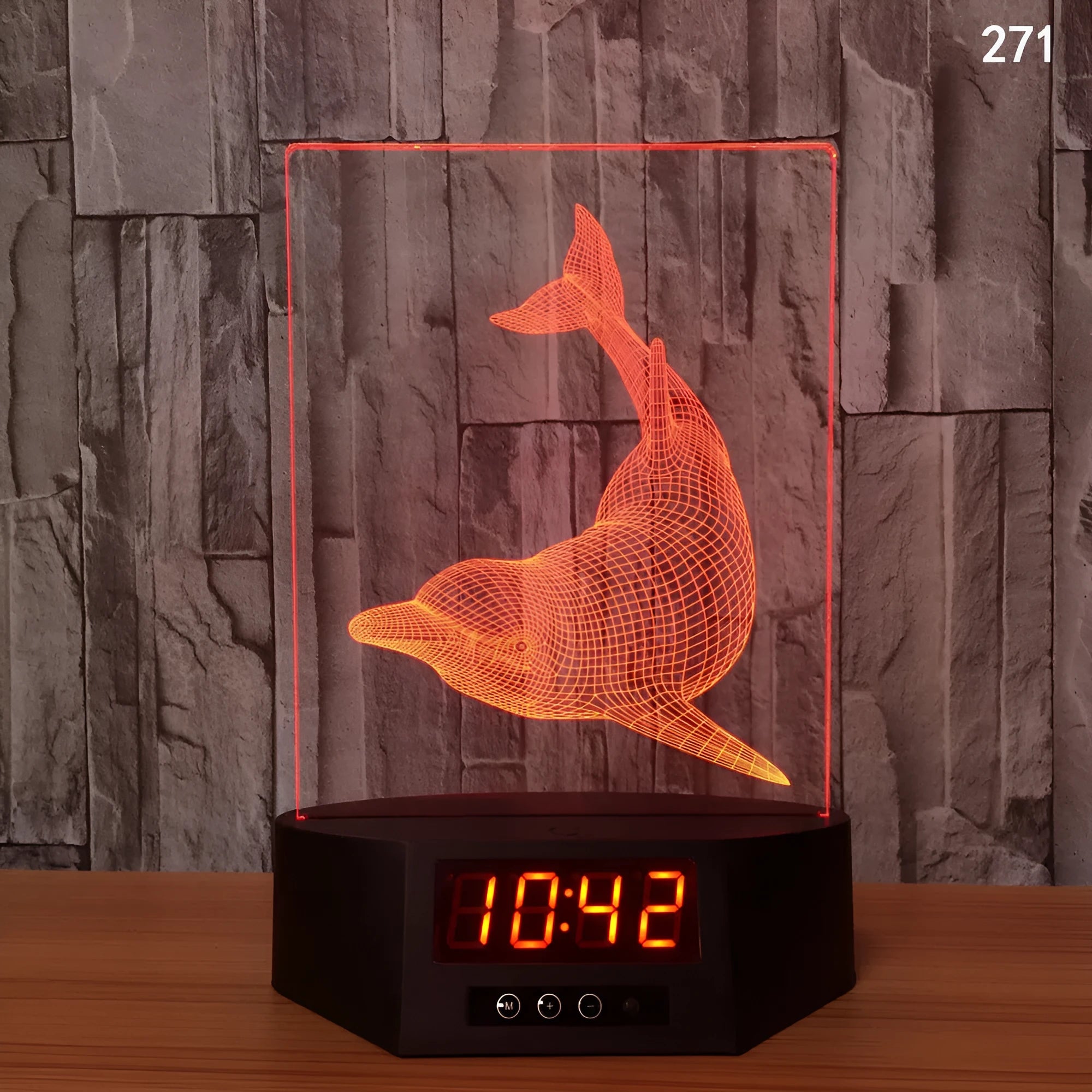 Glowing blue dolphin 3D night light with wireless charging base and remote control on wooden table