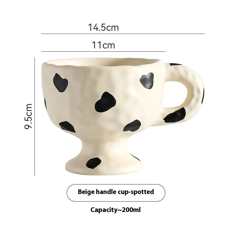 Hand-pinched irregular ceramic mug in a solid colour, showing unique handmade shape.