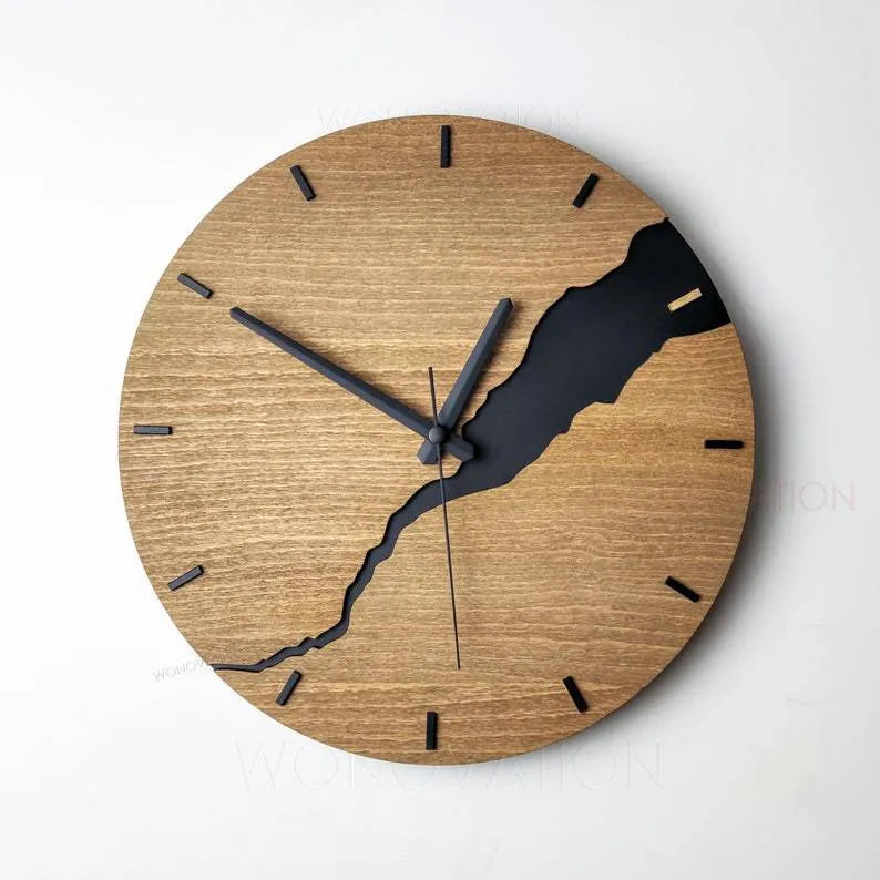 Modern simple wooden wall clock with Arabic numerals on face, shown in a neutral colour finish.