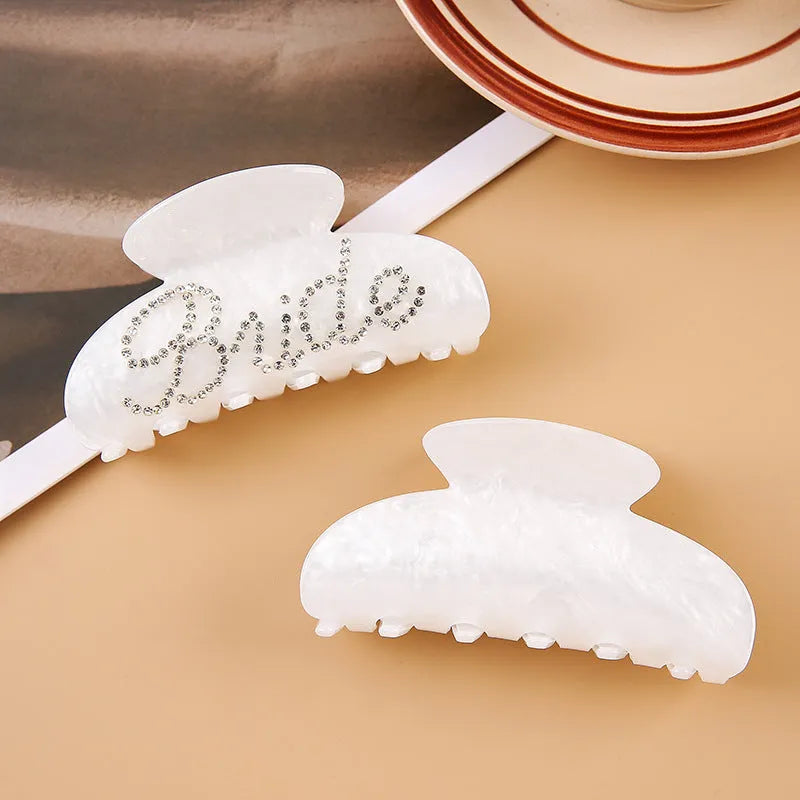 Pink and white acrylic barrette hair clip with diamond spot drilling and English letters.