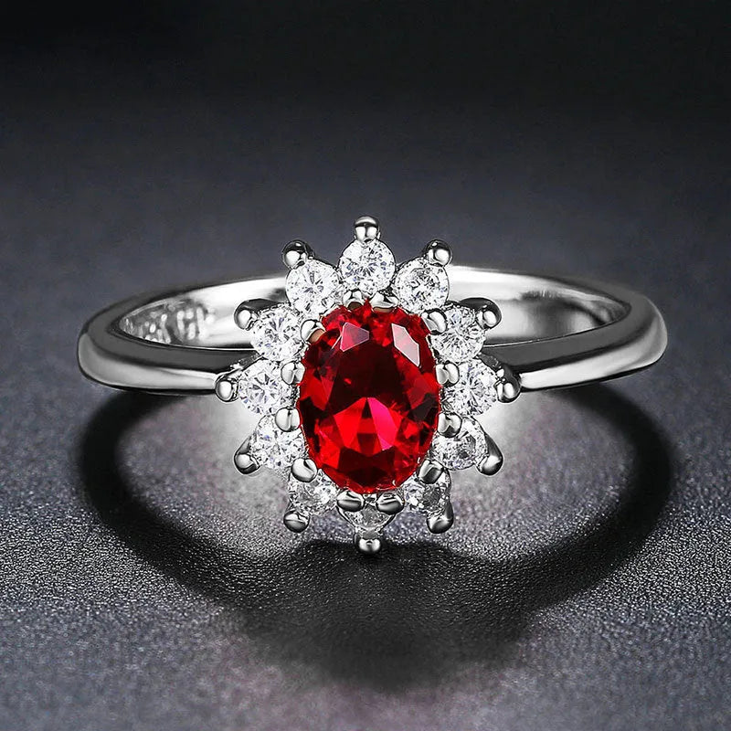 Women's copper flower ring with moissanite centre, shown in green, sapphire blue, and pomegranate red colour options.