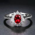 Women's copper flower ring with moissanite centre, shown in green, sapphire blue, and pomegranate red colour options.
