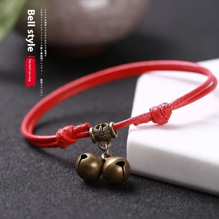 Small dog wearing adjustable nylon rope collar with brass bell in black, red or coffee colour