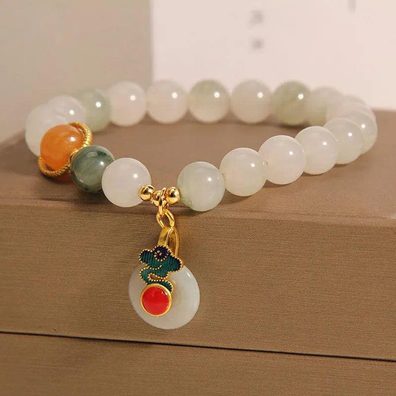 Women's ice jade bracelet with a pearl on the jade buckle.
