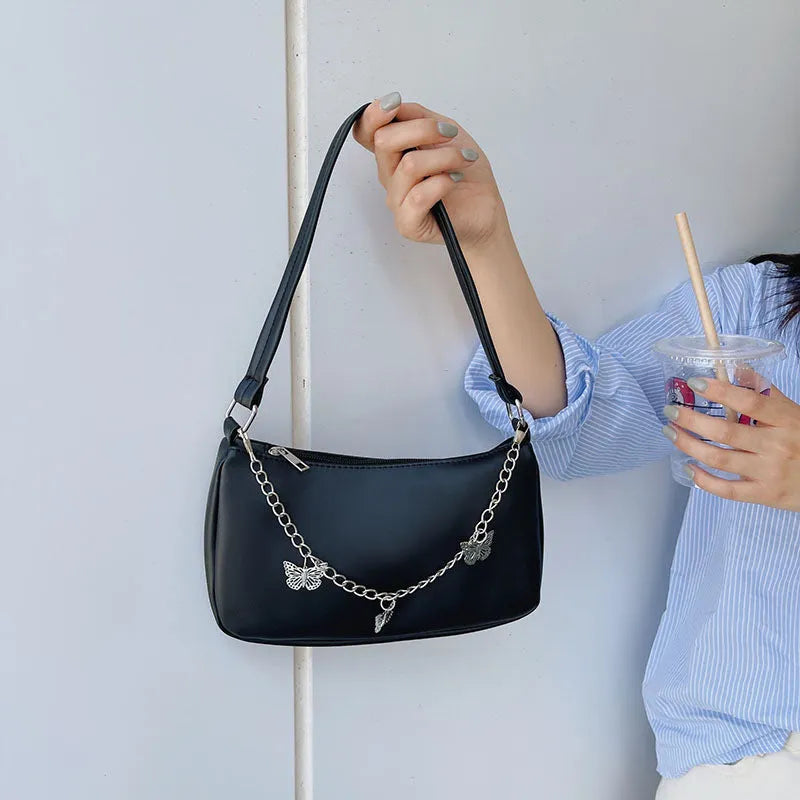 Butterfly chain crossbody bag in PU leather with a retro style, shown in light blue.