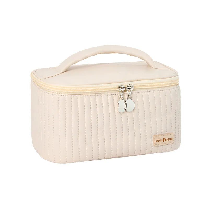Open-top pink PU leather cake-style makeup bag on a table