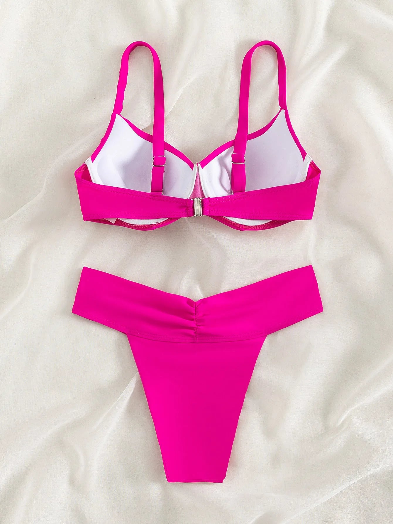 Women's solid colour nylon bikini swimsuit in a briefs style, shown in a fluorescent pink colour.