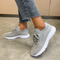 Women's cream running shoes with breathable mesh upper and flat rubber sole