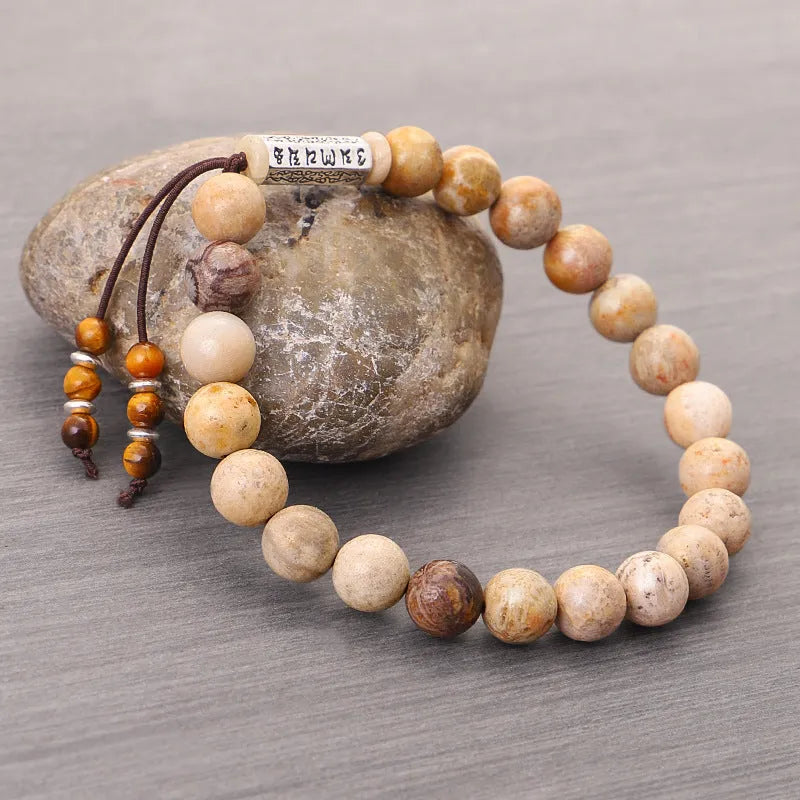 Handmade stone bead bracelet in wood colour on a simple background, showing retro style design.