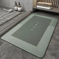 Soft blue oval bathroom floor mat placed on tiles beside a bathtub.