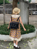 Black women's messenger bag with oil wax leather finish and adjustable crossbody strap