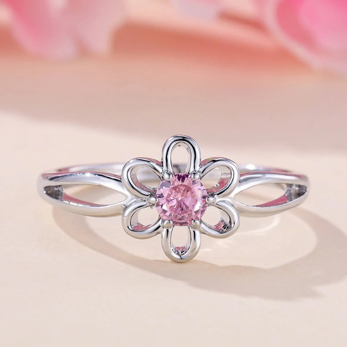 Copper flower hollow-out fashion ring for women with platinum pink diamond plating.